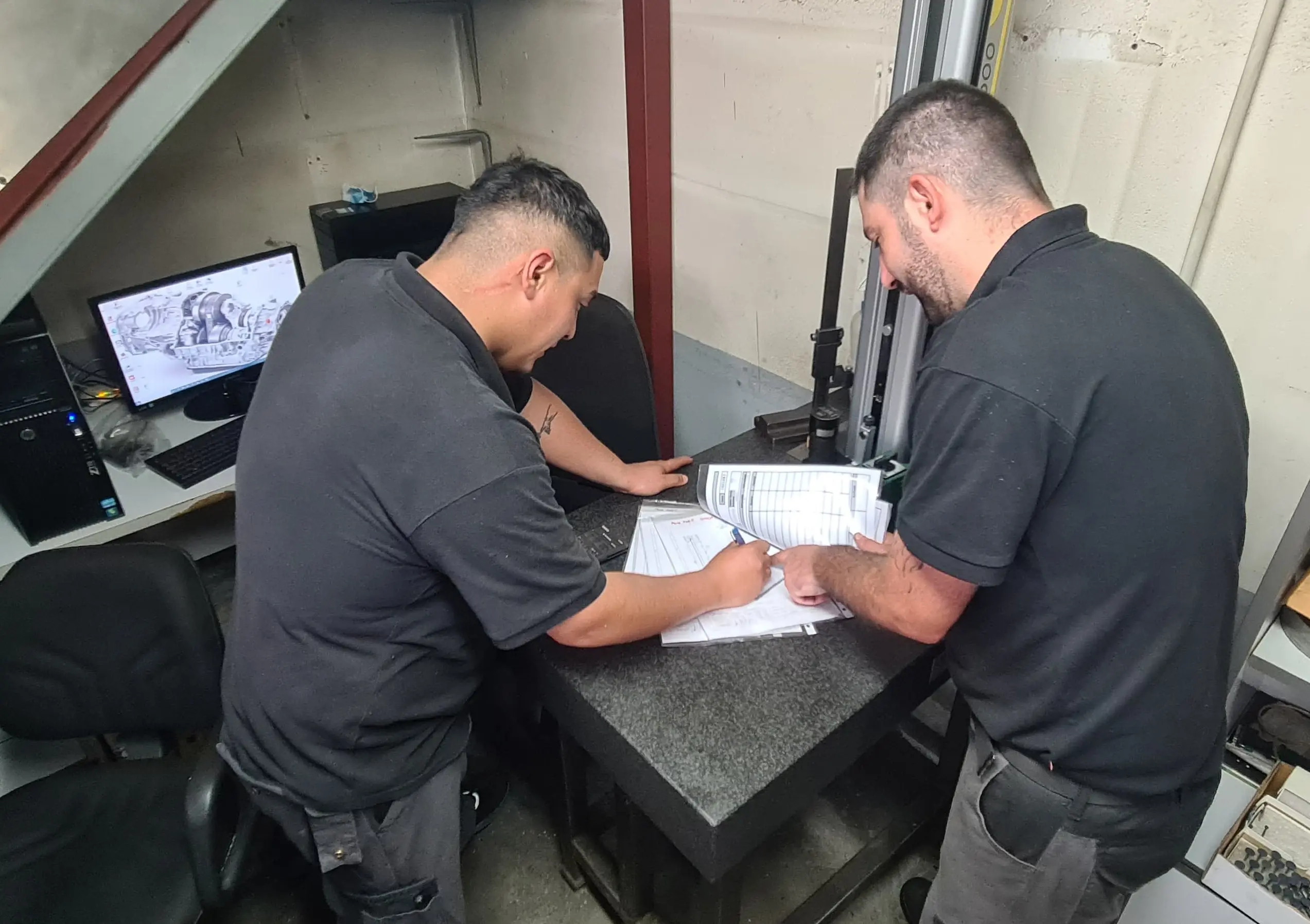 Personal técnico realizando el control de calidad y verificación de planos en taller de mecanizado de precisión en Vitoria-Gasteiz, Álava.
